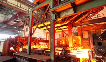 Industrial steel processing factory with molten metal filling the steel moulds